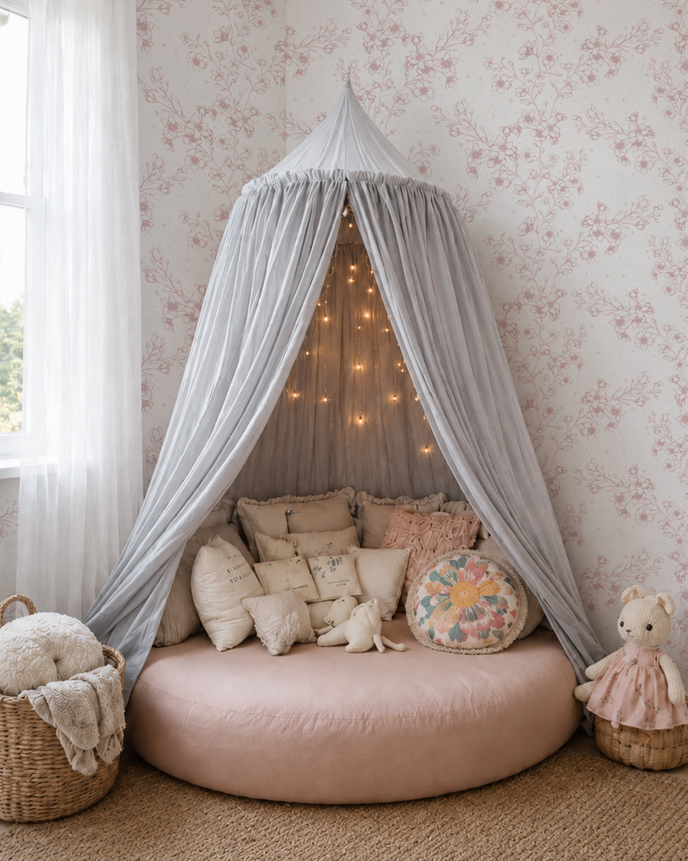 Blossom Whisper Dusty Rose floral wallpaper in a cozy canopy nook with layered cream and blush cushions.