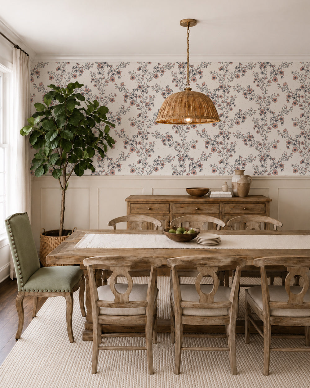 Blossom Whisper Peach floral wallpaper in a warm dining room with rustic wood furniture, cream wainscoting and natural accents.
