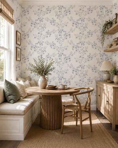 Blossom Whisper Periwinkle floral wallpaper in a bright dining nook with built-in seating, a round wood table and natural accents.