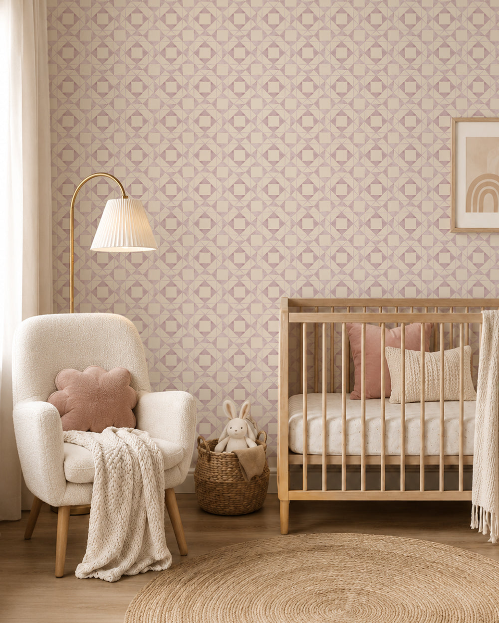 Classic Quilt Blush wallpaper in a cozy nursery with a wood crib, cream armchair and soft blush accents.