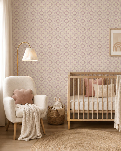 Classic Quilt Blush wallpaper in a cozy nursery with a wood crib, cream armchair and soft blush accents.