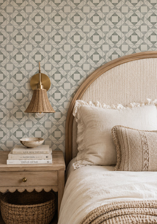 Classic Quilt Deep Sage wallpaper in a cozy bedroom with a curved wood headboard, cream bedding and woven lighting.