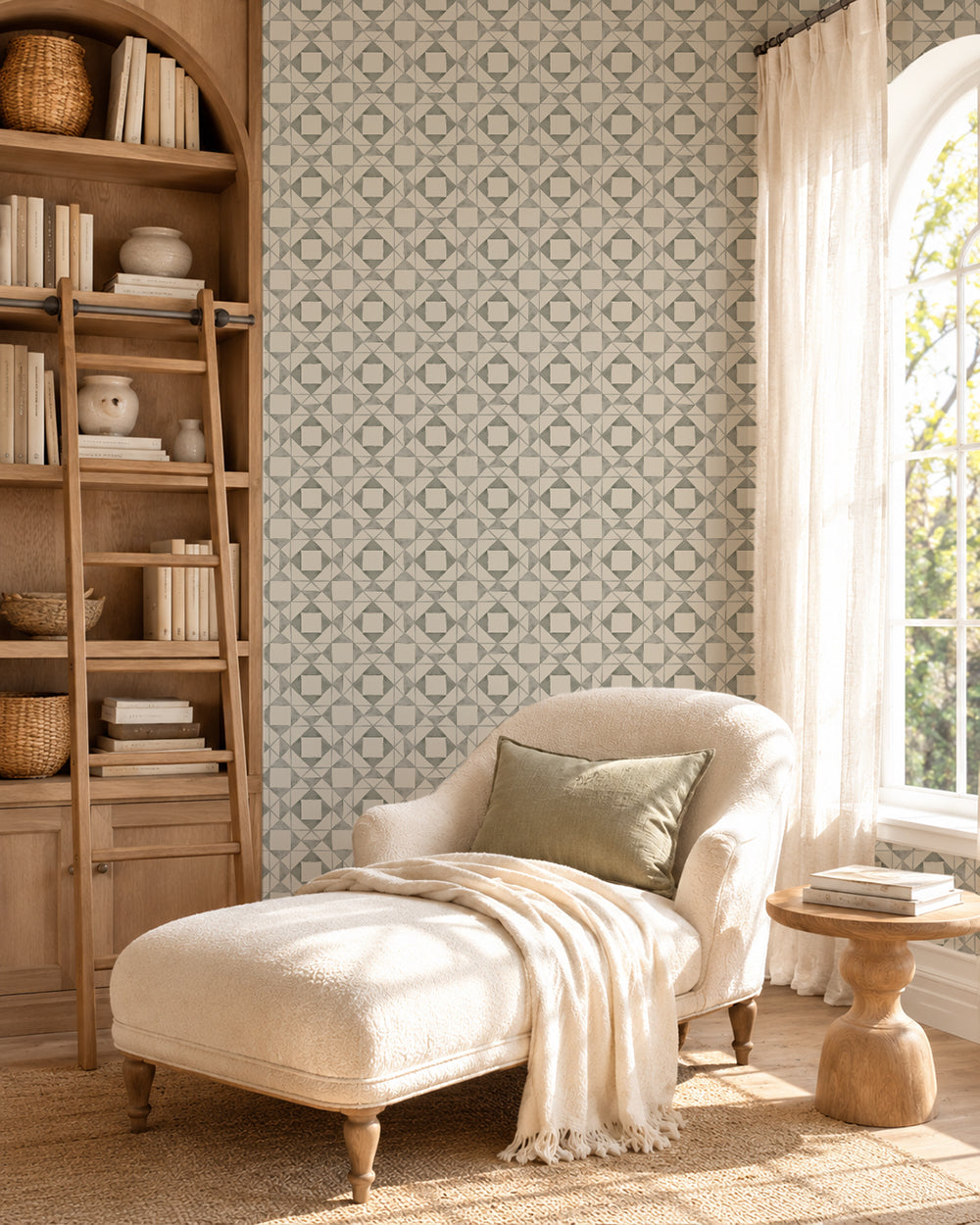 Classic Quilt Deep Sage wallpaper in a cozy reading nook with a cream chaise, wood shelving and natural light.