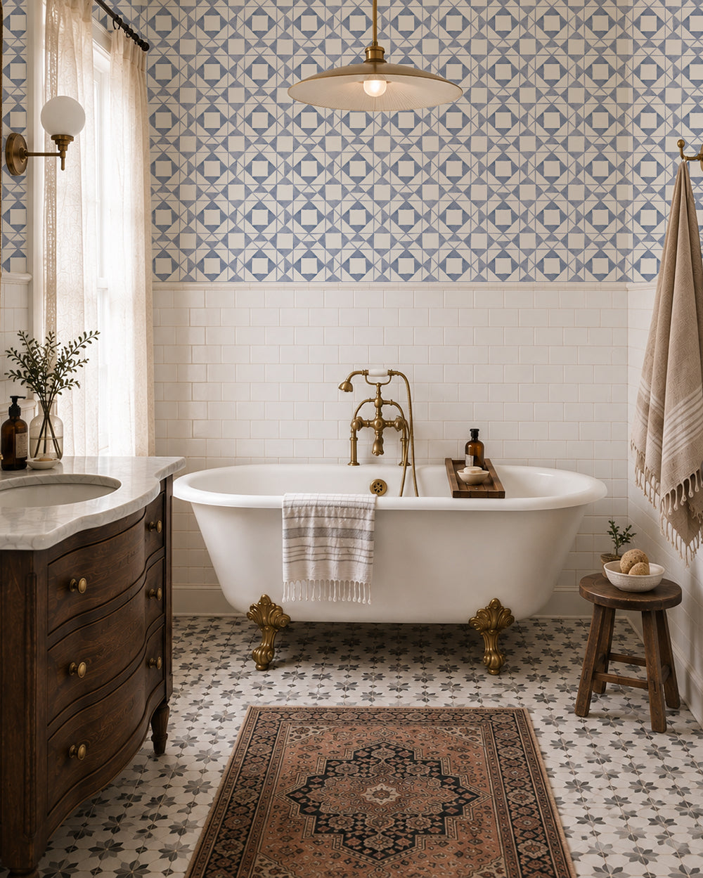Classic Quilt Dusty Blue wallpaper in a vintage bathroom with a clawfoot tub, wood vanity and brass accents.
