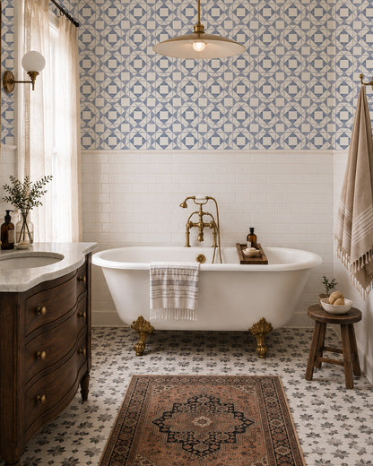 Classic Quilt Dusty Blue wallpaper in a vintage bathroom with a clawfoot tub, wood vanity and brass accents.