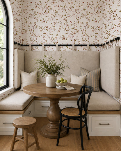 DelicateDreams floral wallpaper with olive and chestnut branches in a cozy dining nook with built-in seating and wood furniture.