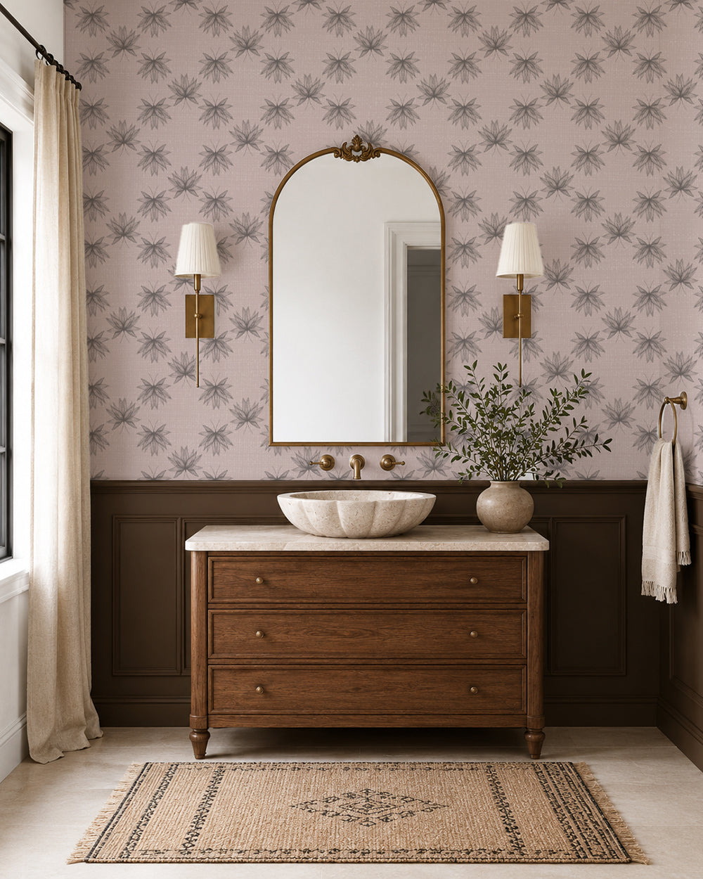 Flutter Dusty Blush wallpaper in an elegant bathroom with a wood vanity, dark wainscoting and brass accents.