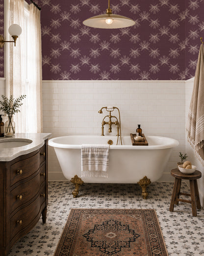 Flutter Plum wallpaper in a vintage bathroom with a clawfoot tub, dark wood vanity and brass accents.