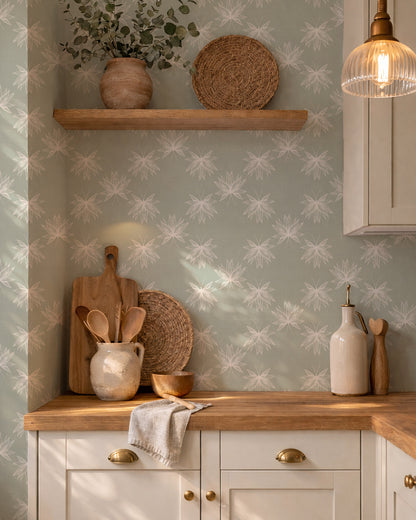 Flutter Soft Sage wallpaper in a cozy kitchen with wood accents, cream pottery and warm natural light.
