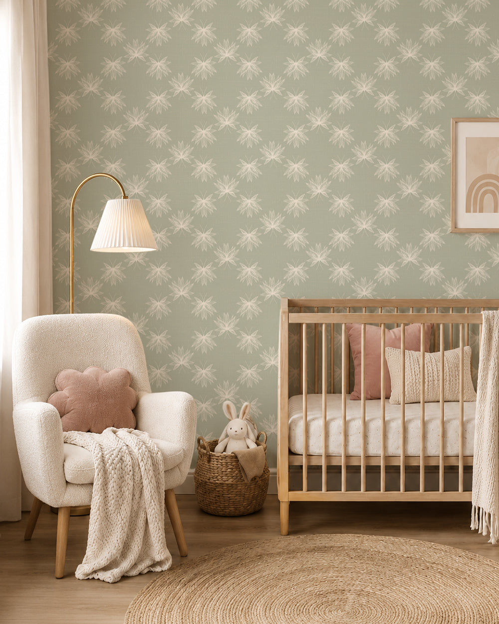 Flutter Soft Sage wallpaper in a cozy nursery with a wood crib, cream armchair and soft blush accents.
