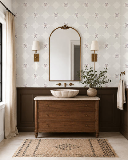 Keepsake Linen wallpaper in an elegant bathroom with a wood vanity, dark wainscoting and brass sconces.