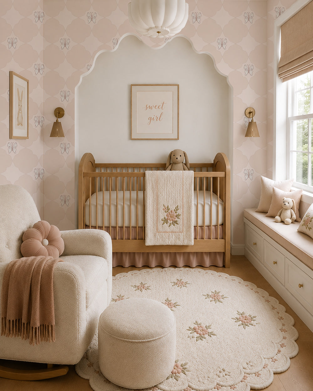 Keepsake Pale Blush wallpaper in a serene nursery with a wood crib, cream chair and soft blush accents.