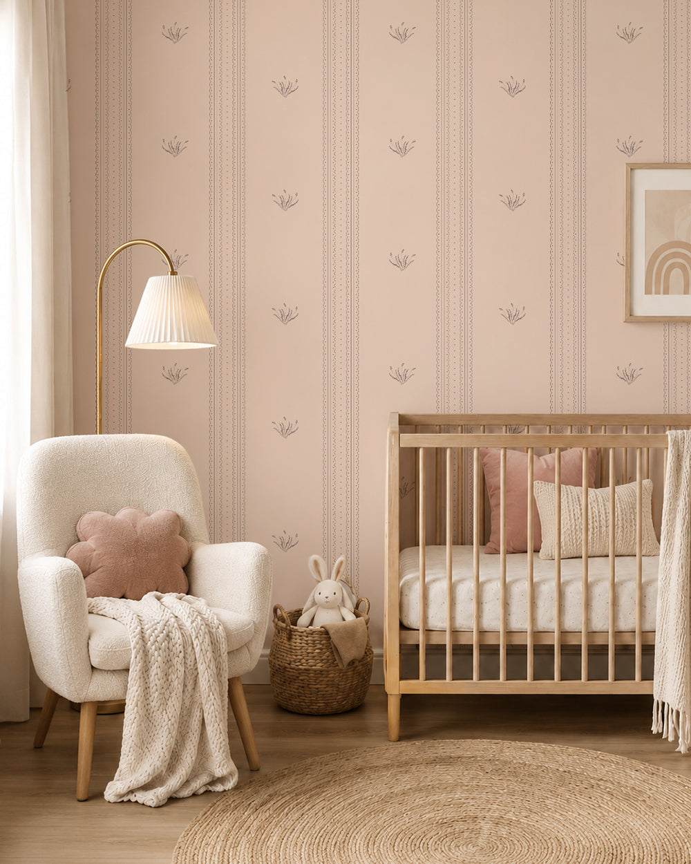 Lace Garden Blush wallpaper in a cozy nursery with a wood crib, cream armchair and blush accents.