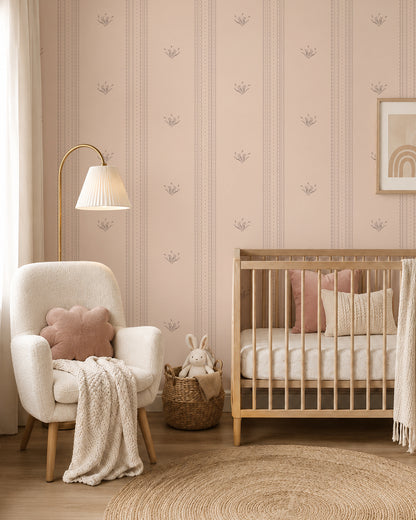Lace Garden Blush wallpaper in a cozy nursery with a wood crib, cream armchair and blush accents.