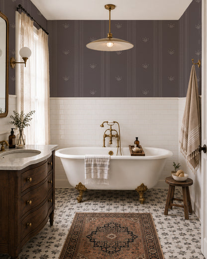 Lace Garden Warm Brown wallpaper in an elegant bathroom with a white tub, dark wood vanity and brass fixtures.