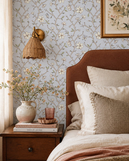 Magnolia Bloom Country Blue wallpaper in a warm bedroom with a rust headboard, cream bedding and natural wood accents