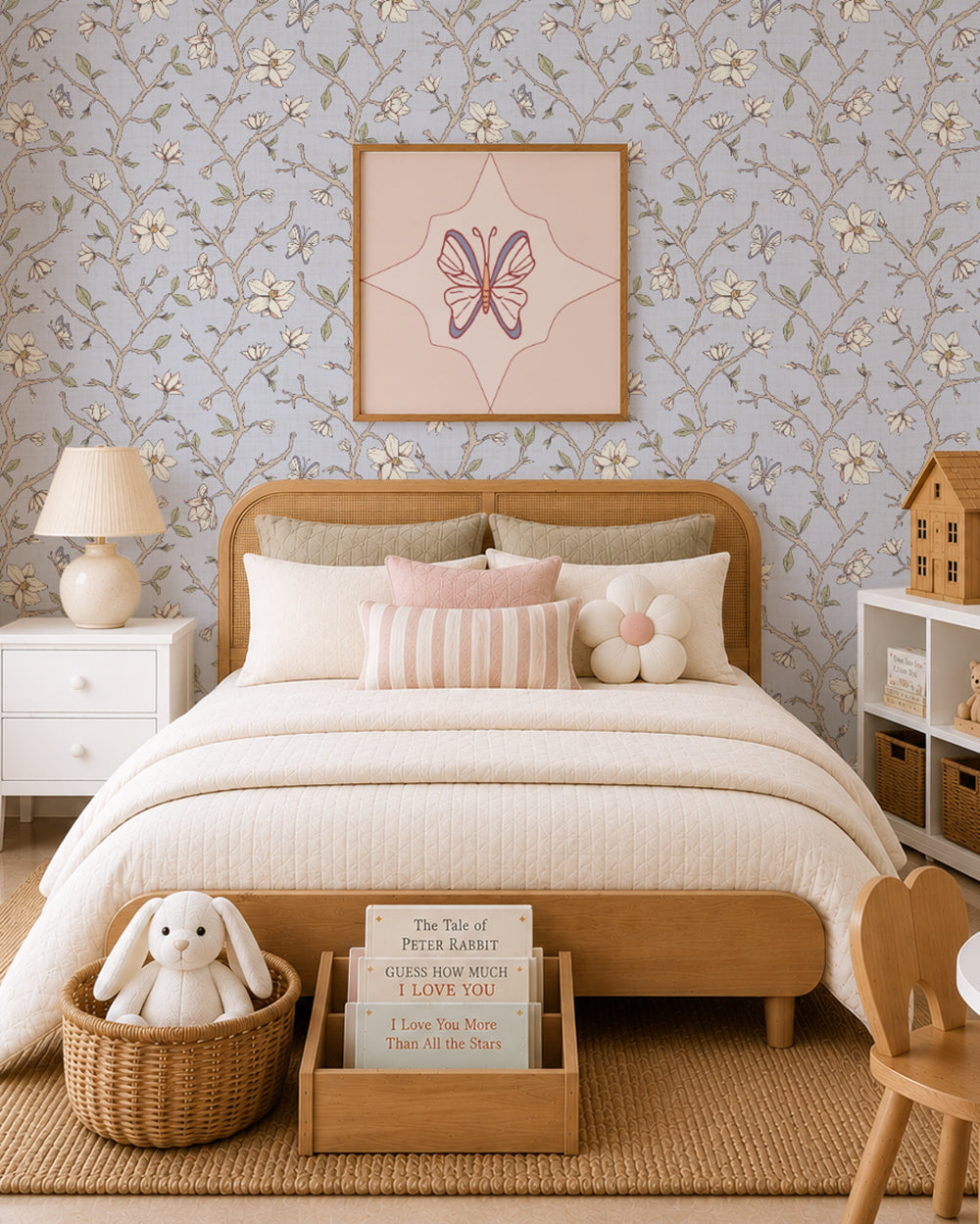 Magnolia Bloom Country Blue wallpaper in a children’s bedroom with a wood bed, cream bedding and soft blush accents.