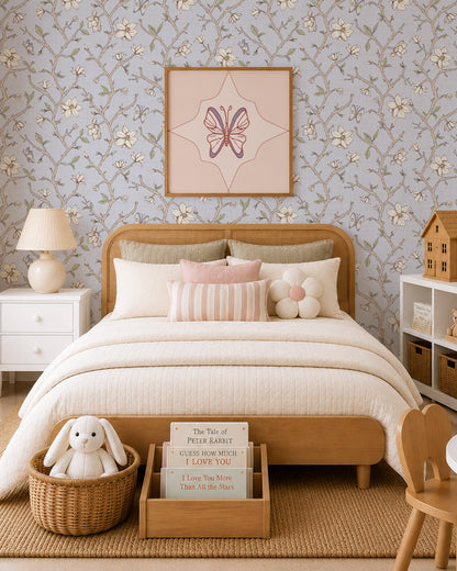 Magnolia Bloom Country Blue wallpaper in a children’s bedroom with a wood bed, cream bedding and soft blush accents.