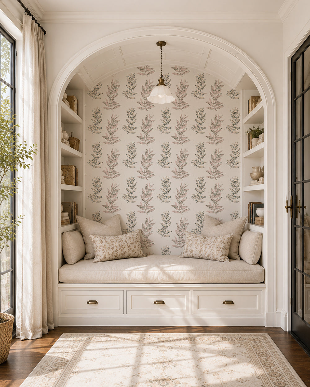Olive Branch Olive wallpaper in a cozy reading nook with built-in shelves, cream cushions and warm natural light.