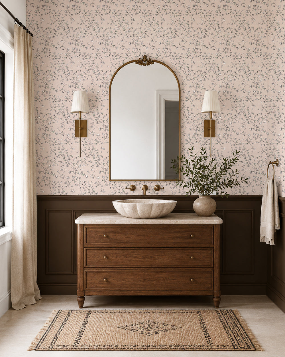 Spring Vine Blush wallpaper in an elegant bathroom with dark wood wainscoting, a wooden vanity and brass accents.