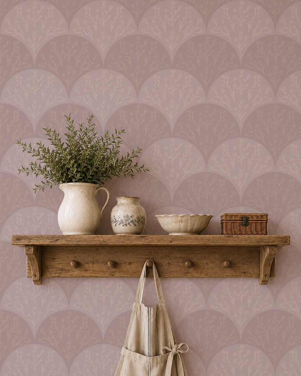 Stitched Meadow Blush wallpaper behind a rustic wood shelf with pottery, greenery and warm natural decor.