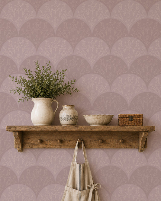 Stitched Meadow Blush wallpaper behind a rustic wood shelf with pottery, greenery and warm natural decor.