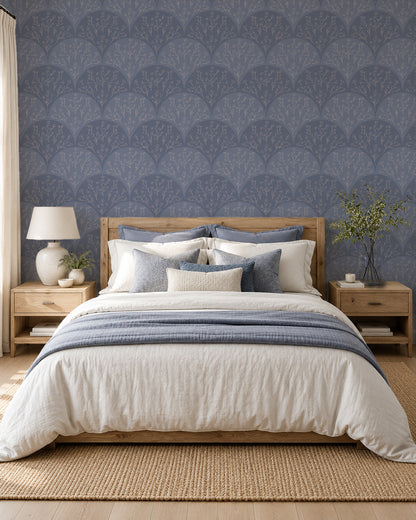 Stitched Meadow Dusty Blue wallpaper in a serene bedroom with light wood furniture and layered neutral bedding.