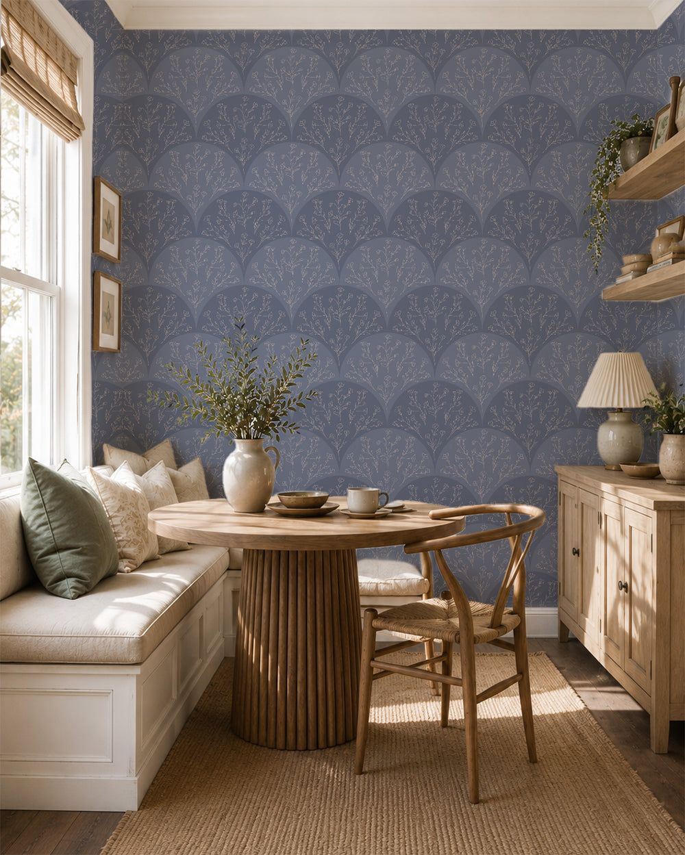 Stitched Meadow Dusty Blue wallpaper in a cozy dining nook with warm wood furniture and soft neutral decor.