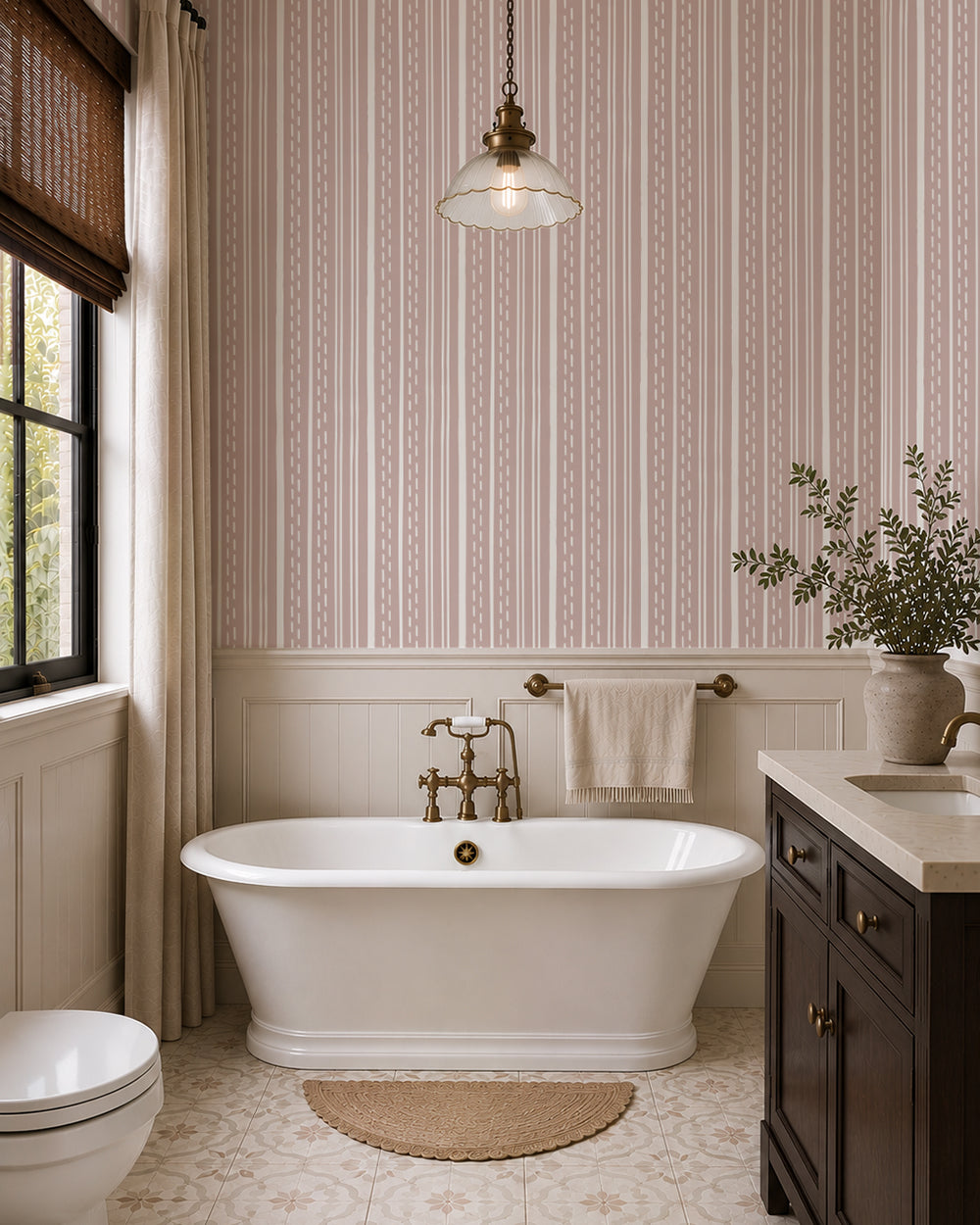 Ticking Stripe Soft Blush wallpaper in a bright bathroom with a freestanding tub, dark wood vanity and cream paneling.