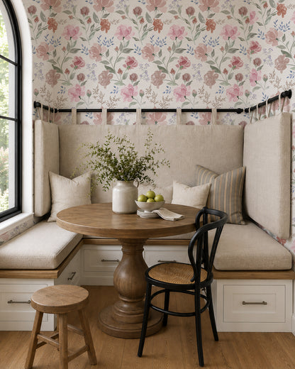 Vintage Peony Blush floral wallpaper in a cozy dining nook with built-in seating, a round wood table and neutral accents.