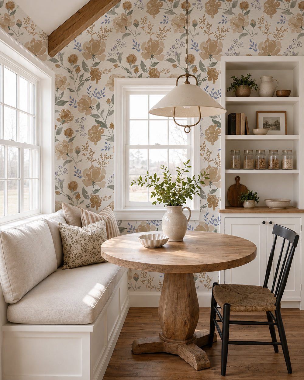 Vintage Peony Honey floral wallpaper in a bright dining nook with built-in seating, a round wood table and natural accents.